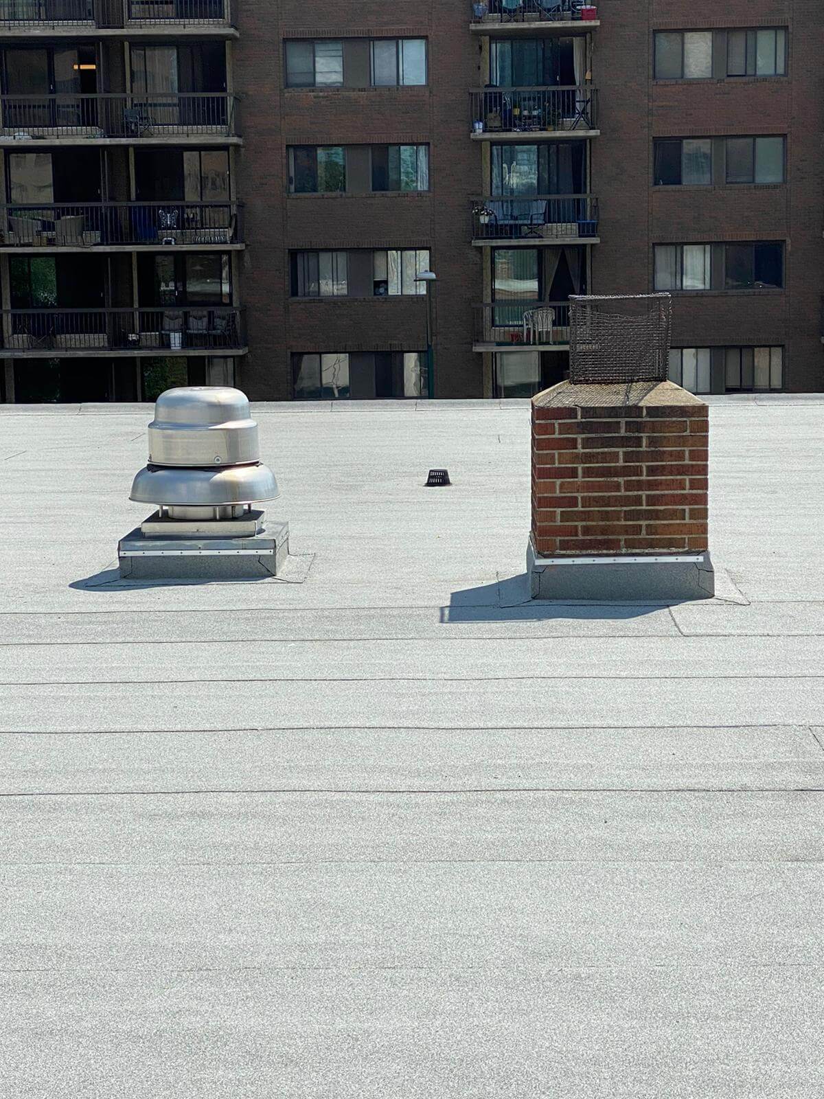 Commercial_Roofing_Fast_Repairs Commercial flat roof being repaired quickly to minimize business disruption in Calgary