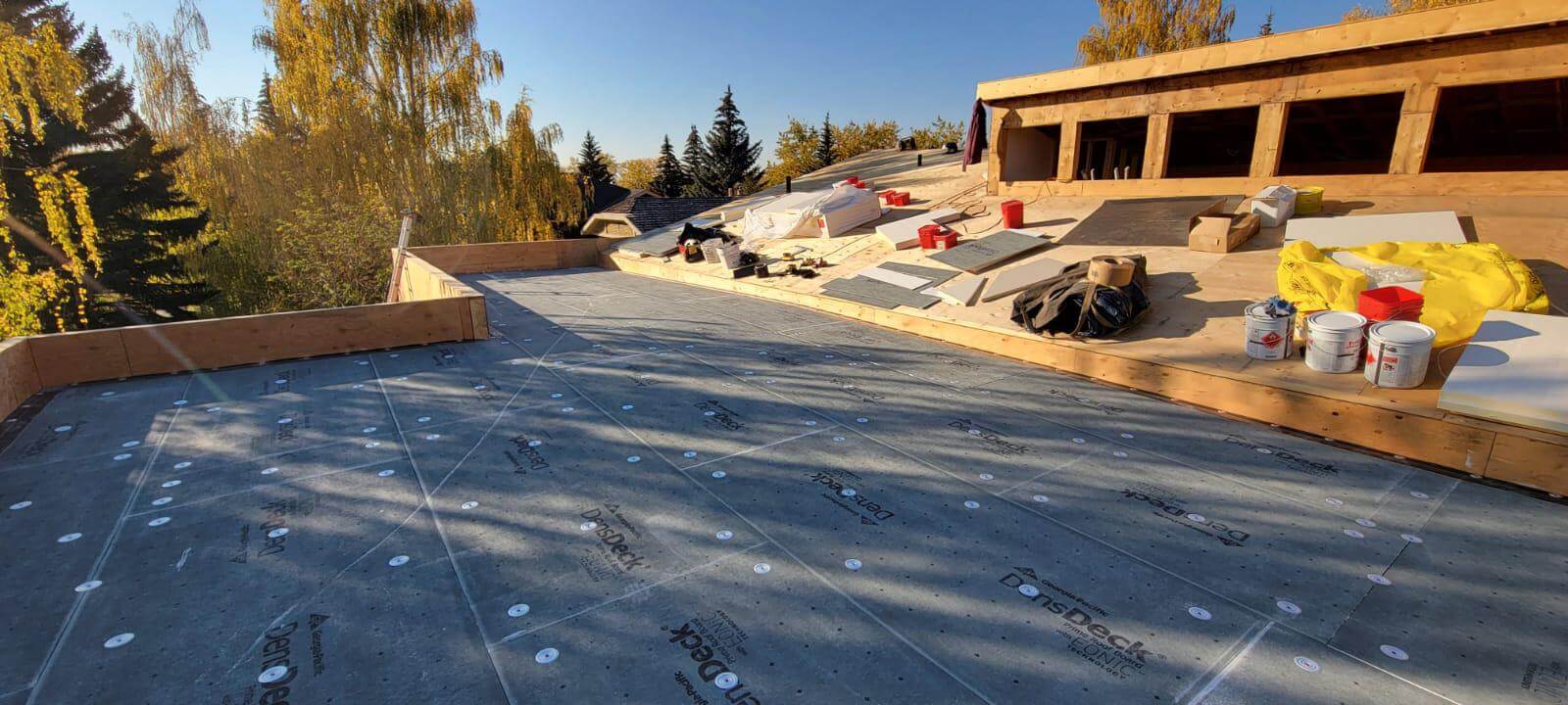 Flat roof membrane repair being performed by professional roofers in Calgary