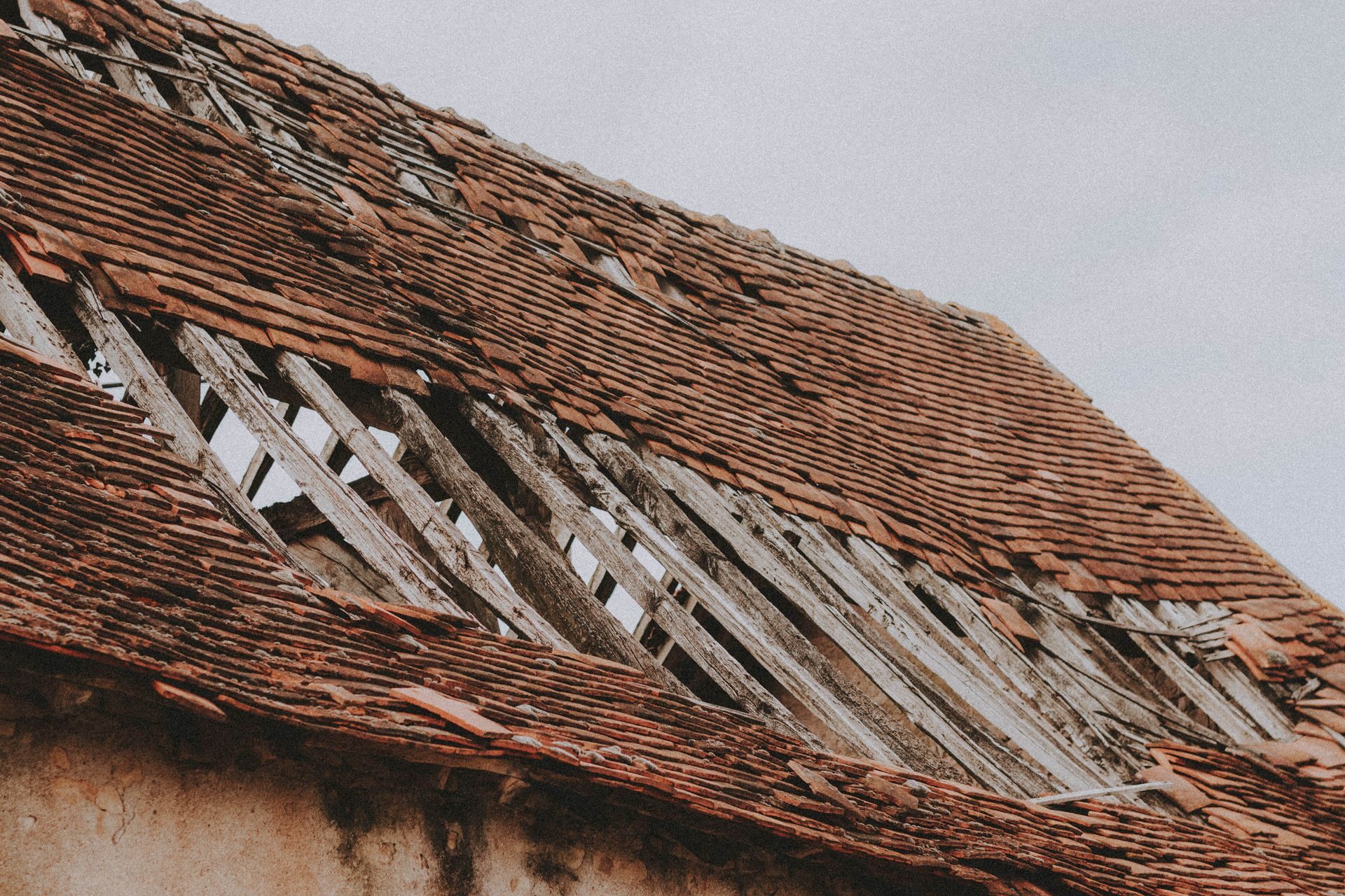 Clay_Tile_Cracked_Broken_Slipped_Tiles Clay tile roof with cracked and slipped tiles exposing the battens beneath
